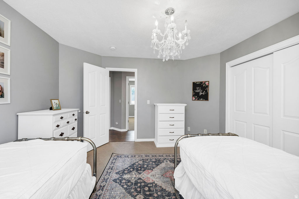 Interior room featuring neutral wall paint, a crystal chandelier, and a carpeted floor