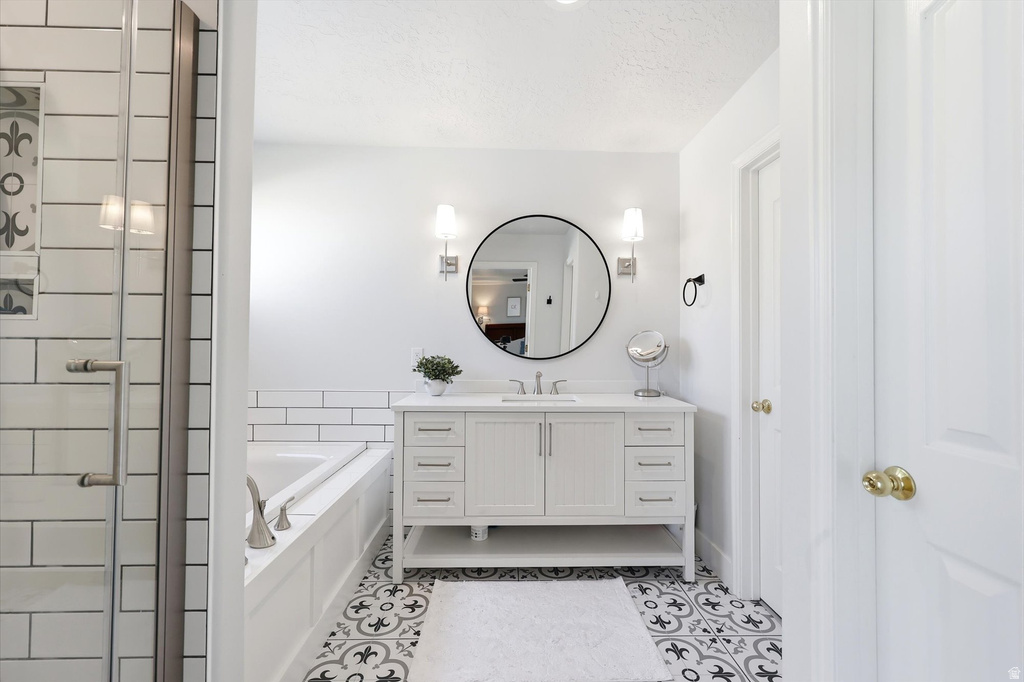 White vanity with dual doors and multiple drawers, featuring a round mirror and sconce lighting