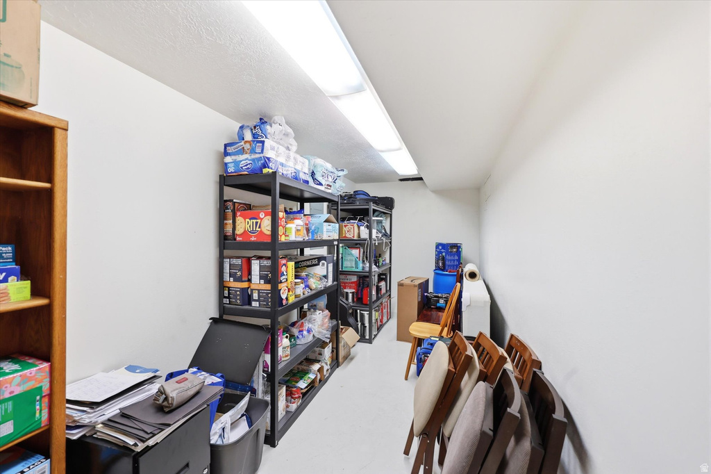 Elongated storage space featuring white walls, ceiling, and flooring