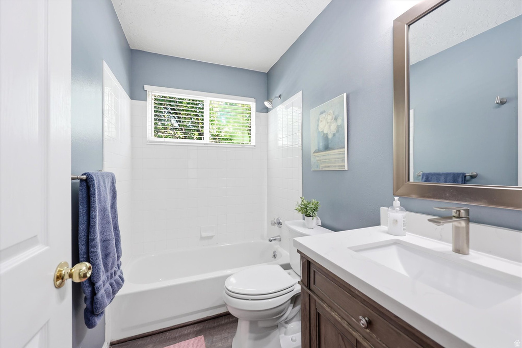 Bathroom featuring a white vanity with an integrated sink, brushed nickel faucet, and a framed mirror