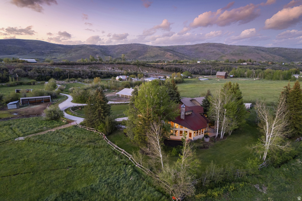 Mountain property with a multi-level residence featuring a red metal roof and stucco exterior