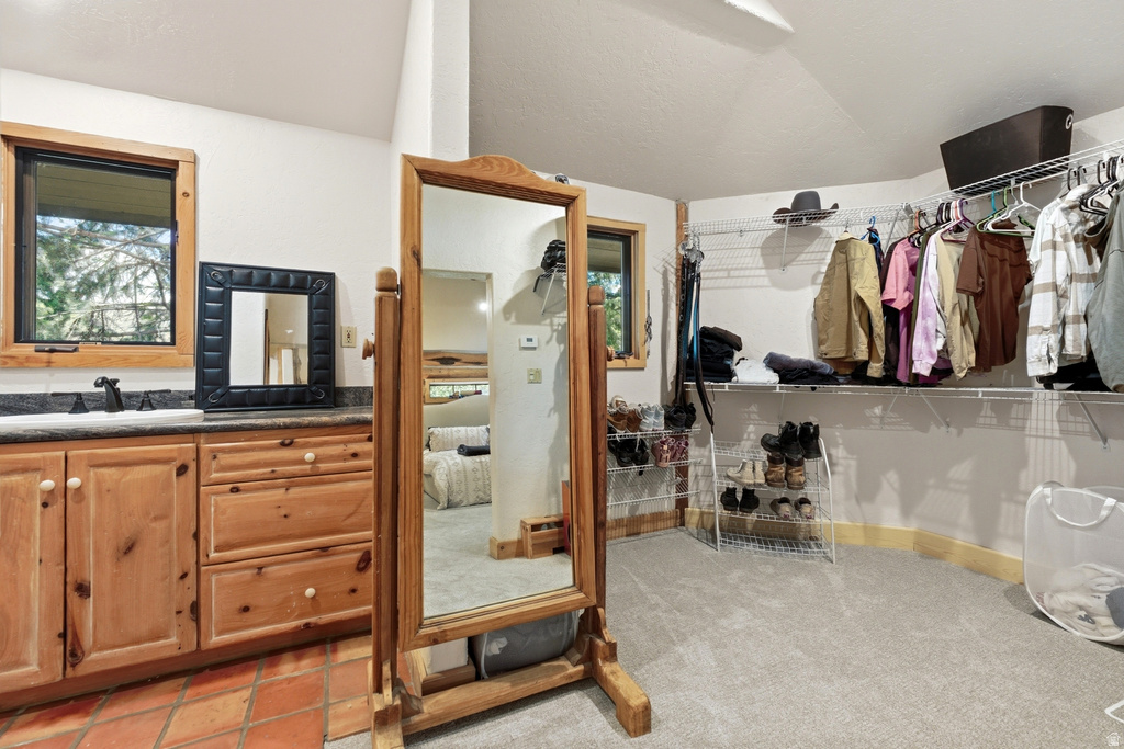 Spacious walk-in closet featuring wire shelving and hanging rods