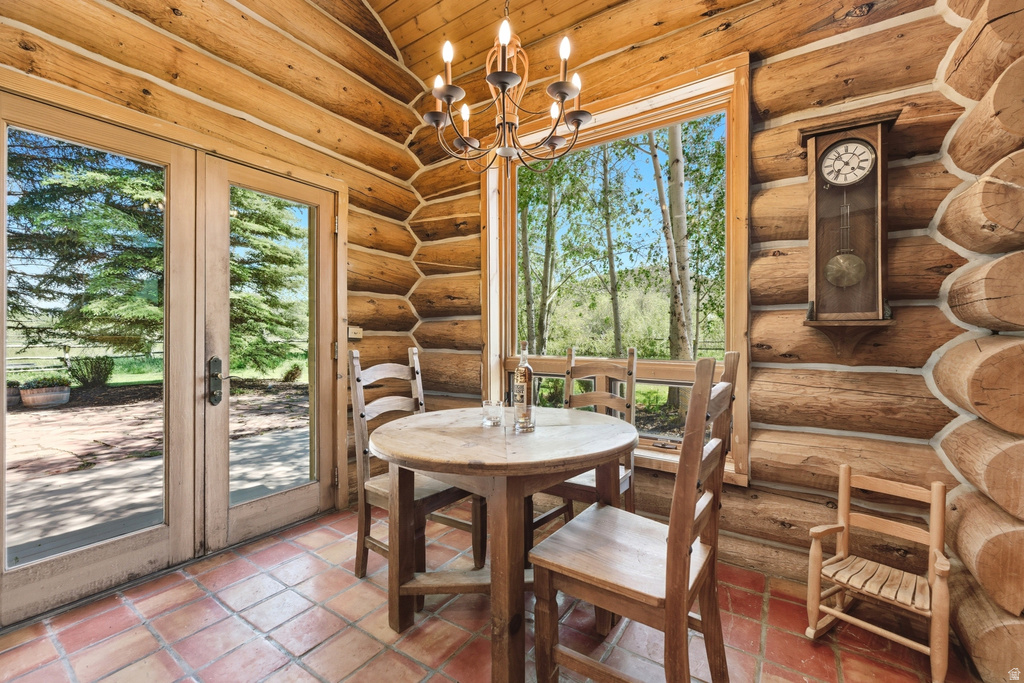 Wood-finish log walls and ceiling feature a rustic chandelier