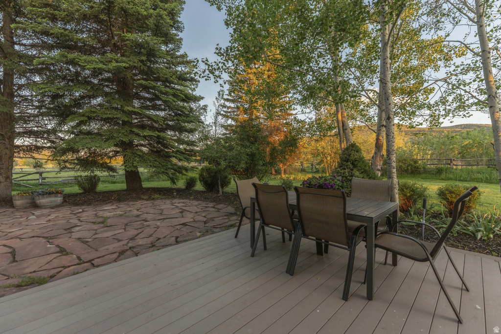 Spacious outdoor deck with an adjacent flagstone patio