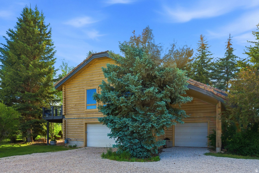 Log-style siding exterior with a multi-car garage