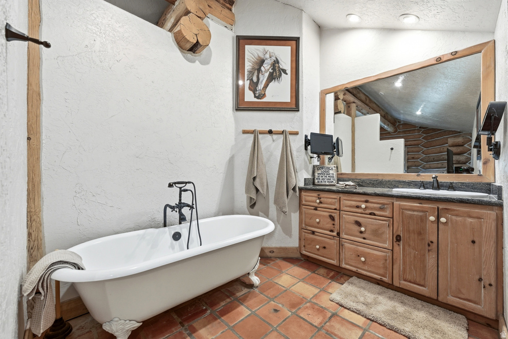 Bathroom featuring a white clawfoot tub with a black freestanding faucet