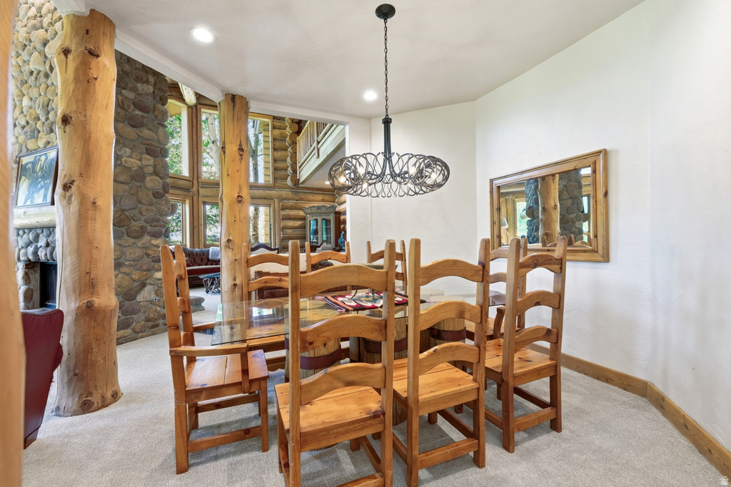 Dining area with a wrought iron chandelier and recessed lighting