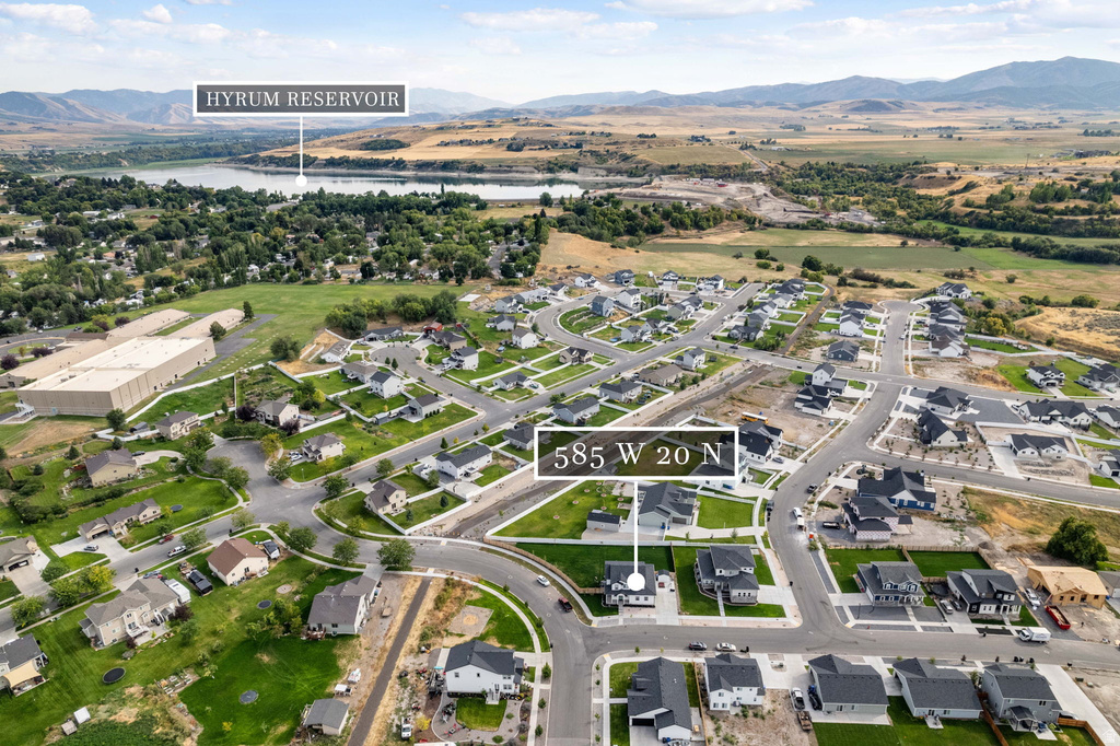 Aerial perspective showcasing a developed residential neighborhood with a mix of established and under-construction homes