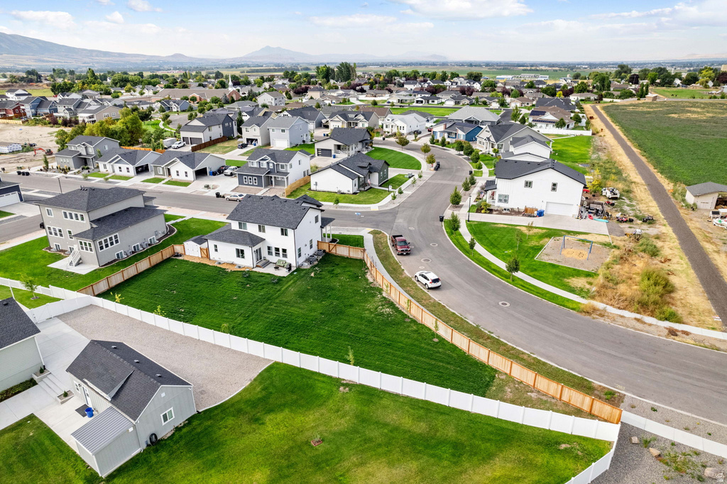 New construction residential development featuring a paved street, established sidewalks, and individual homes with landscaped yards