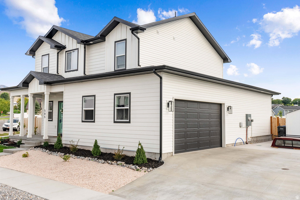 Modern Colonial-style exterior featuring white siding with black trim accents