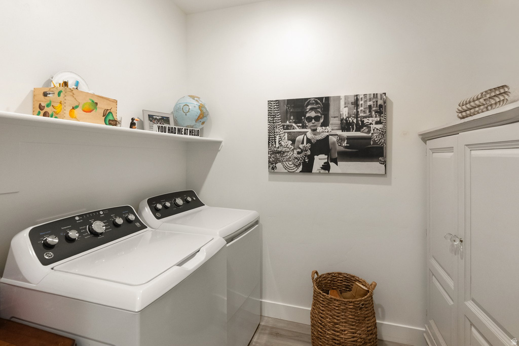 Dedicated laundry area featuring a white storage shelf and a tall white cabinet with glass knobs