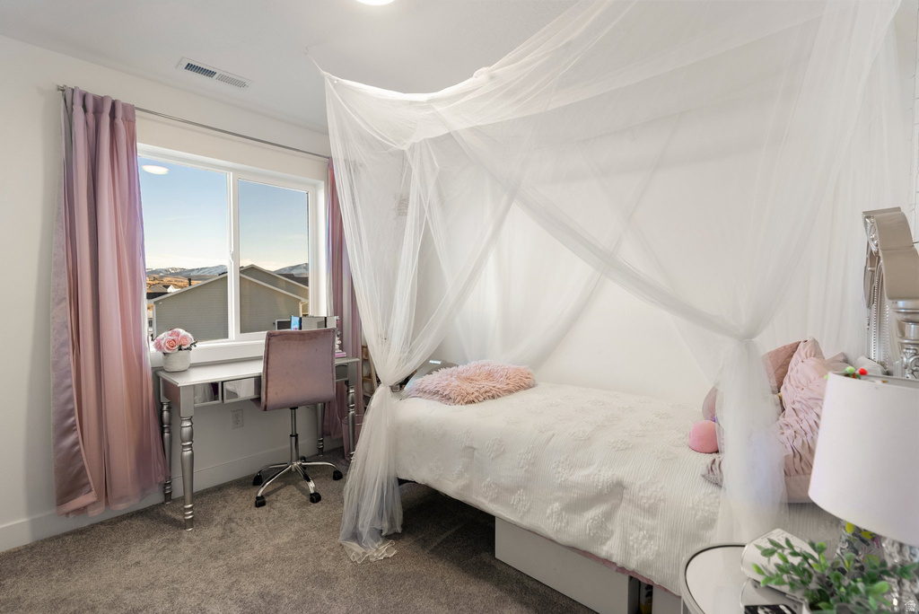 Carpeted room featuring a large window, recessed lighting, and a built-in air vent