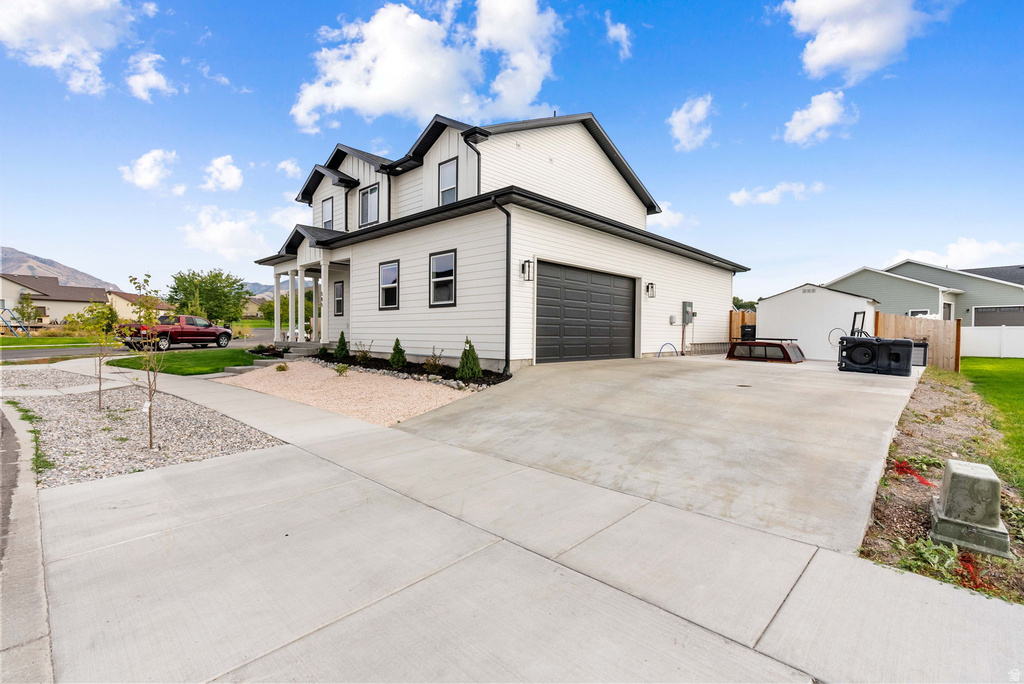 Modern two-story residence with a white exterior and dark trim