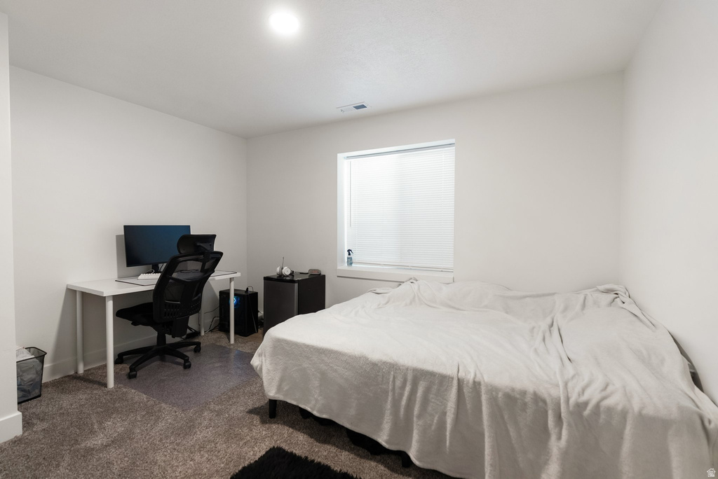 Bedroom featuring neutral carpeting and white walls