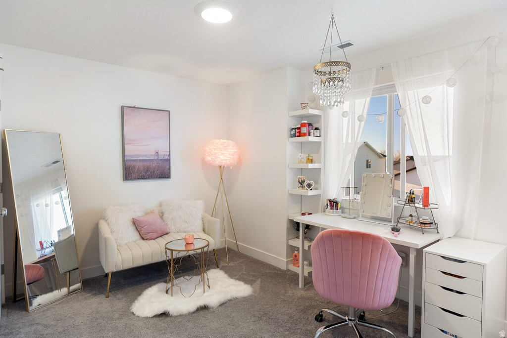 White walls with recessed ceiling lighting, a clear window with sheer drapery, and a crystal chandelier