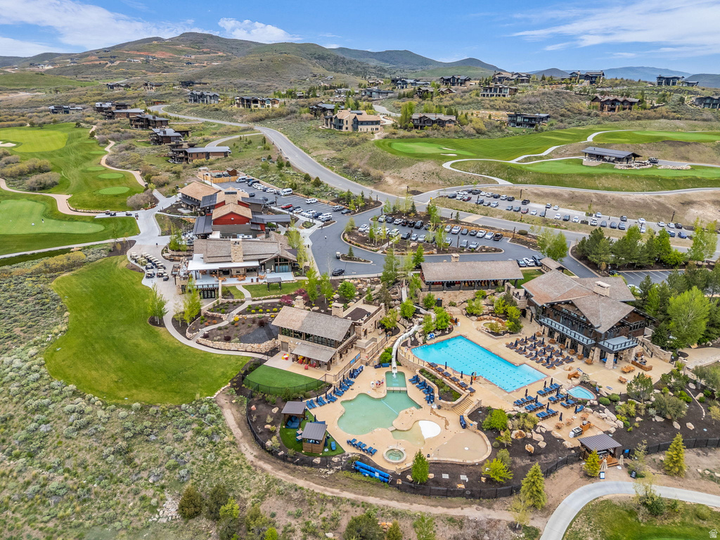 Expansive community amenities including a multi-level pool with integrated slide, a separate resort-style pool, and a hot tub