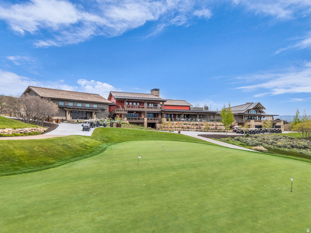 Expansive putting green with multiple flags and golf balls