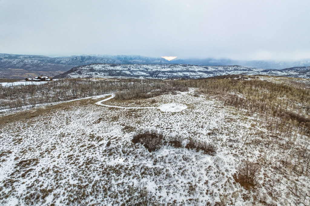 Expansive snow-covered terrain with distant mountain ranges