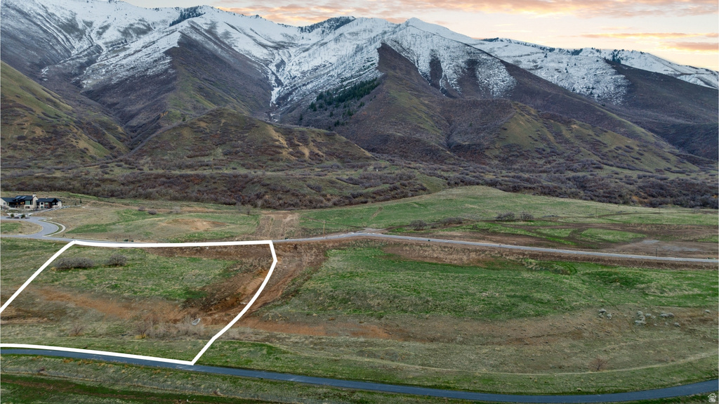 Expansive land parcel featuring open terrain and a paved roadway