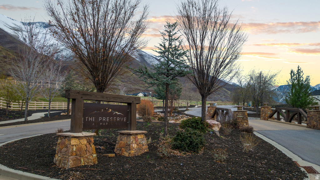 Stone and wood community entrance sign with dark mulch landscaping