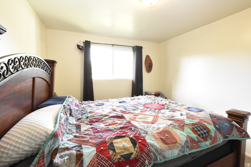 Room featuring an overhead ceiling light fixture, neutral wall color, and a window with dark curtains