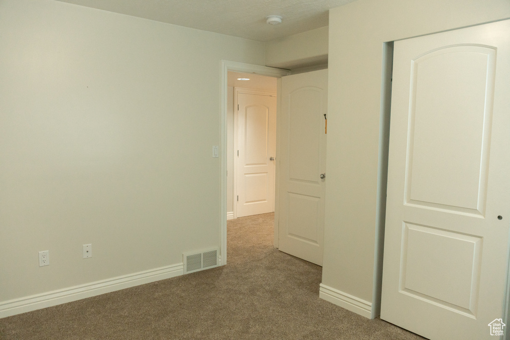 Neutral-toned carpeting paired with light wall finishes