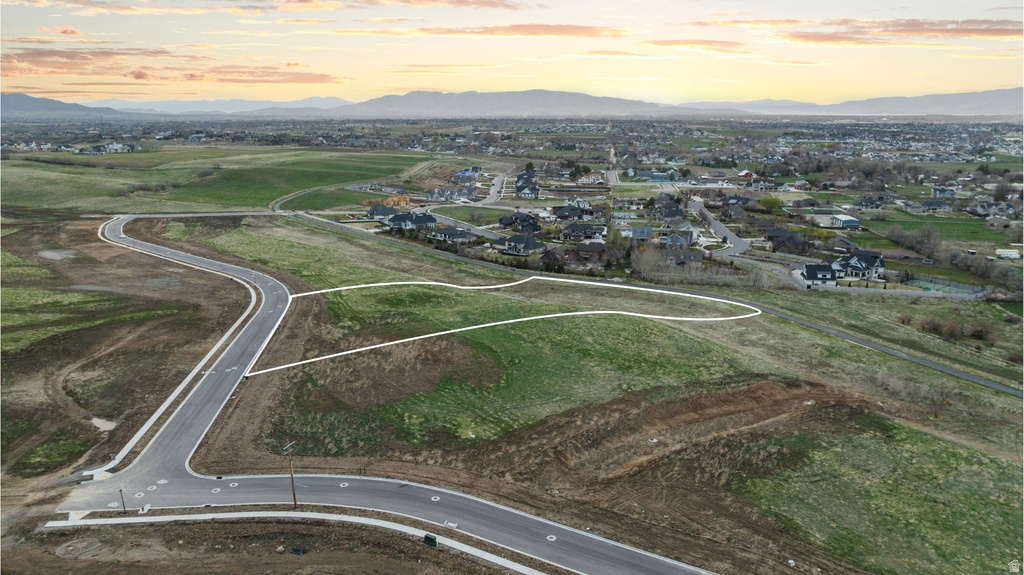 Expansive green space with defined property boundaries, offering a clear development opportunity