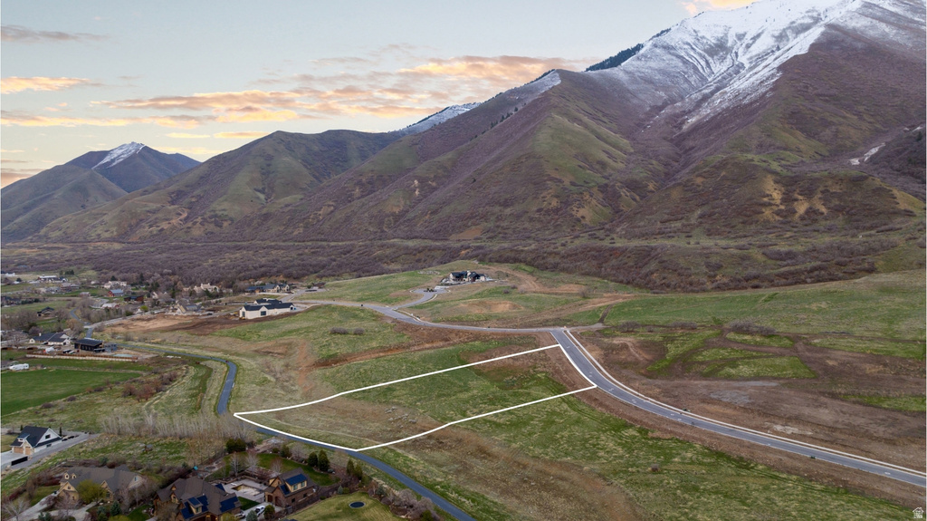Expansive lot offering mountain backdrops and a paved road frontage