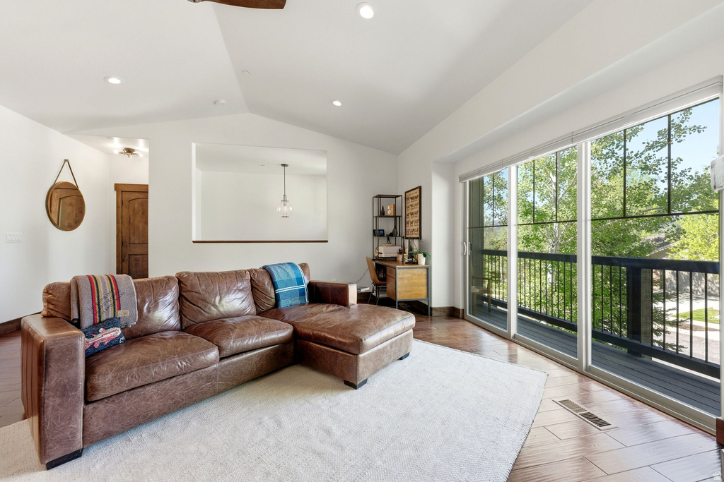 Spacious living area featuring large sliding glass doors opening to an outdoor deck