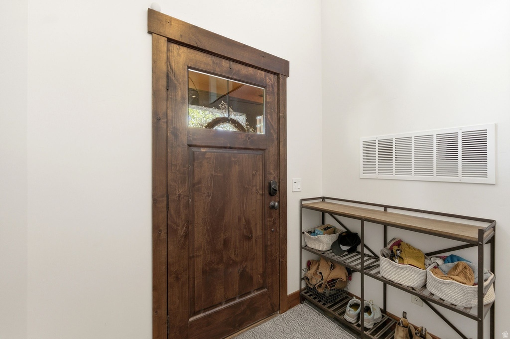 Rich wood-finish entry door with clear glass panel