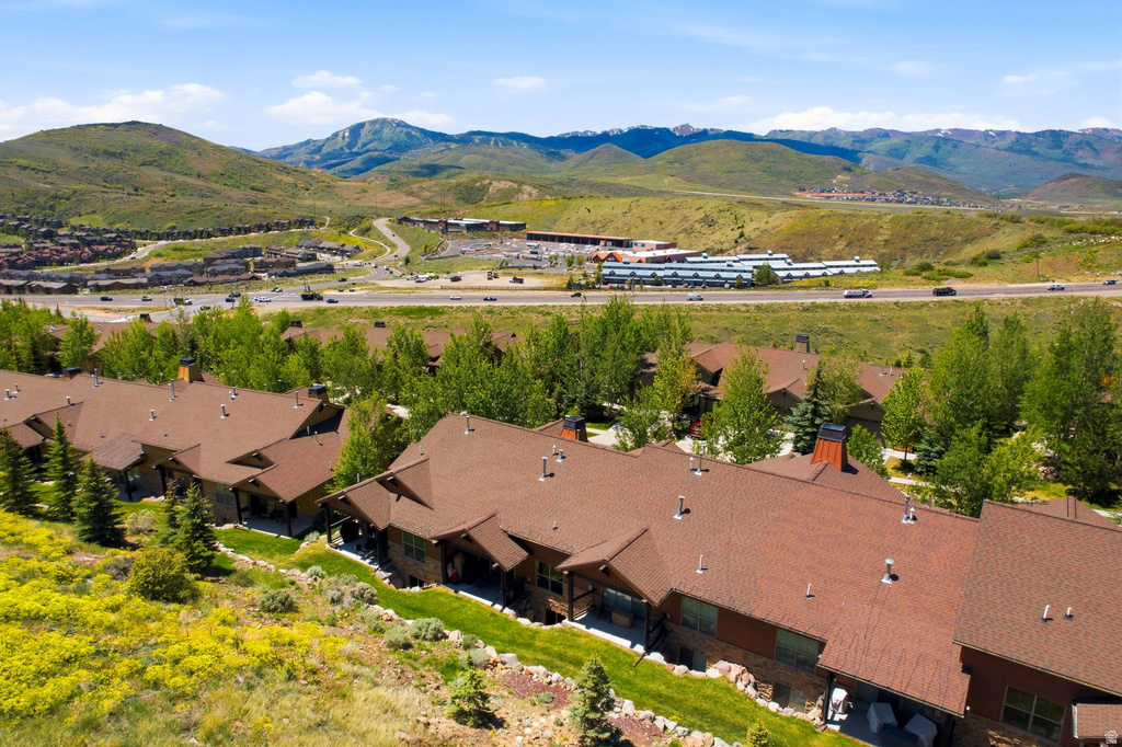 Terraced townhome-style residences with brown shingle roofs and stone accents