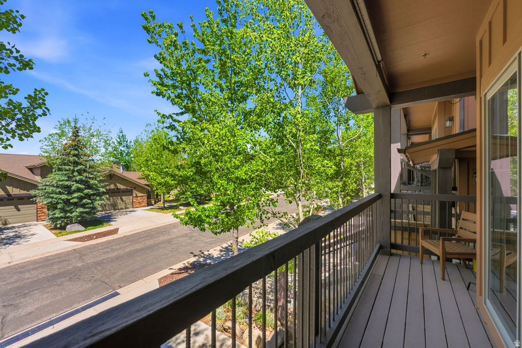 Private balcony with composite decking and dark wood railings