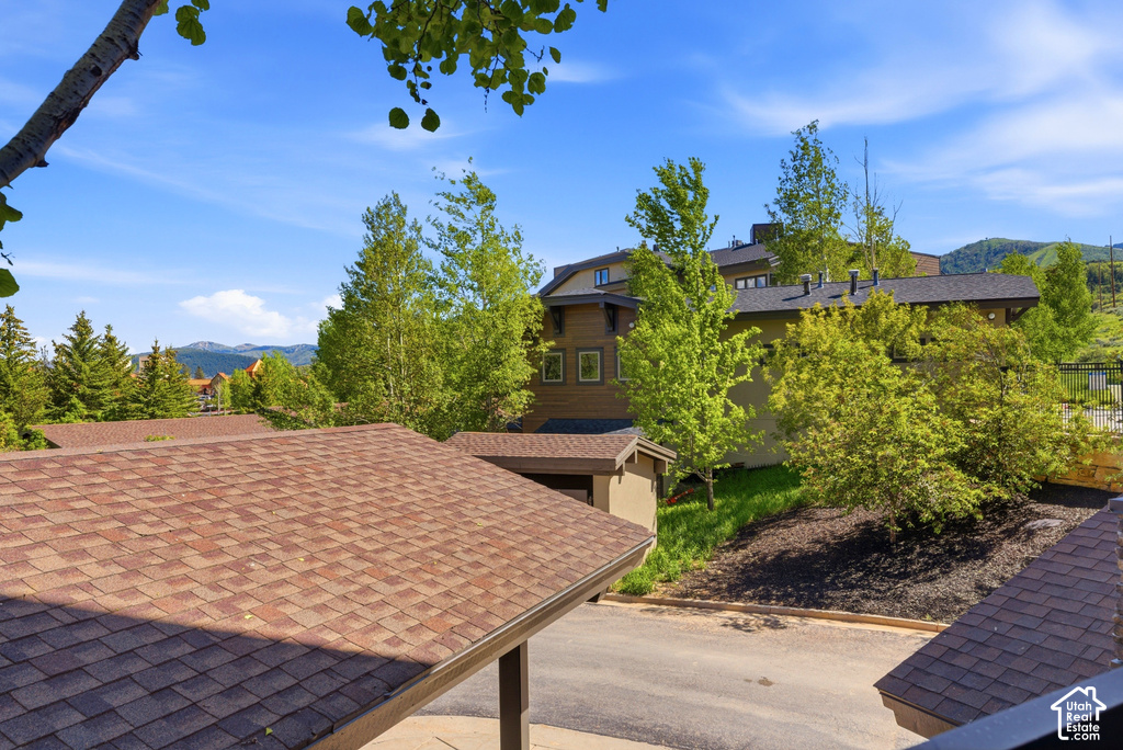 Brown asphalt shingle roof with mountain backdrop