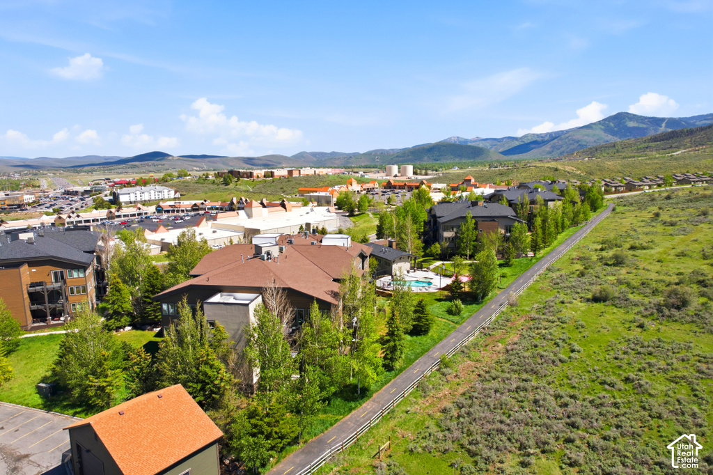 Expansive aerial perspective showcasing a residential development with multiple buildings and a communal swimming pool