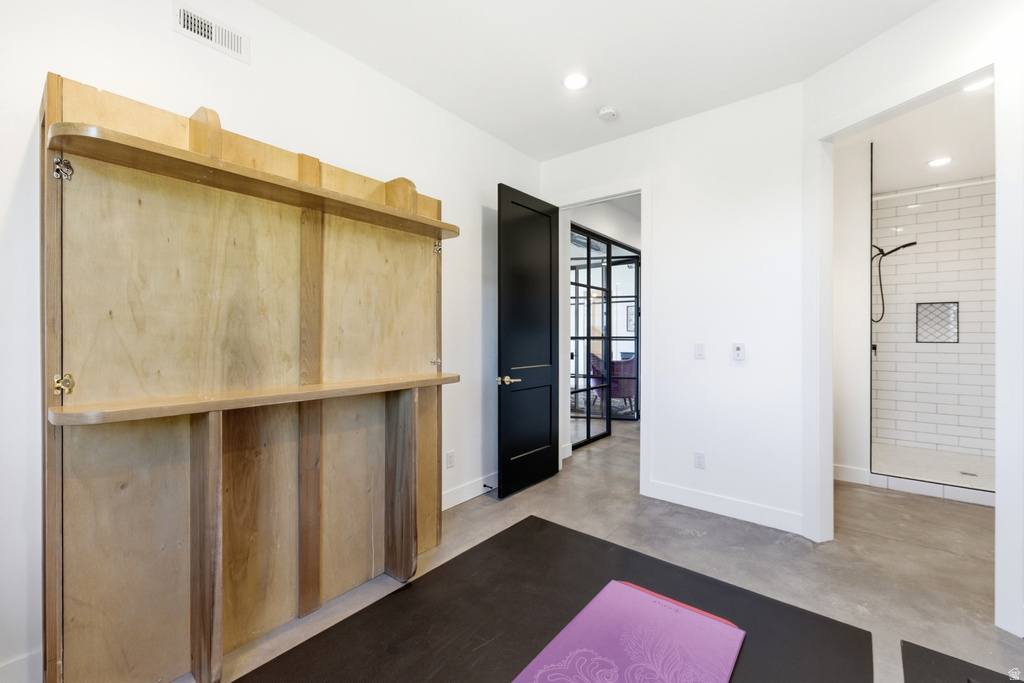 Integrated wall bed system with blonde wood finish and built-in shelving