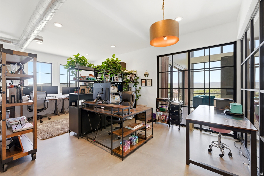 Spacious interior with exposed spiral ductwork and recessed lighting