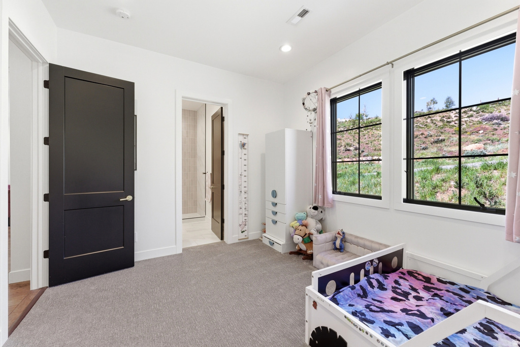 Room featuring light gray carpeting, crisp white walls, and recessed lighting