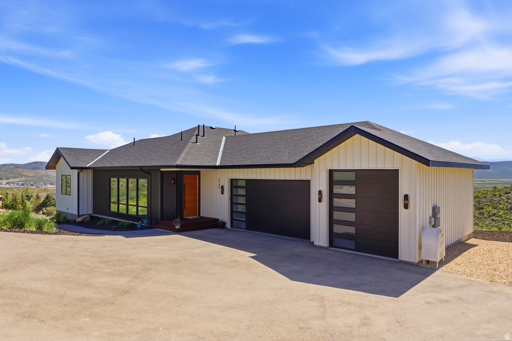 Contemporary single-story residence with a dark asphalt shingle roof