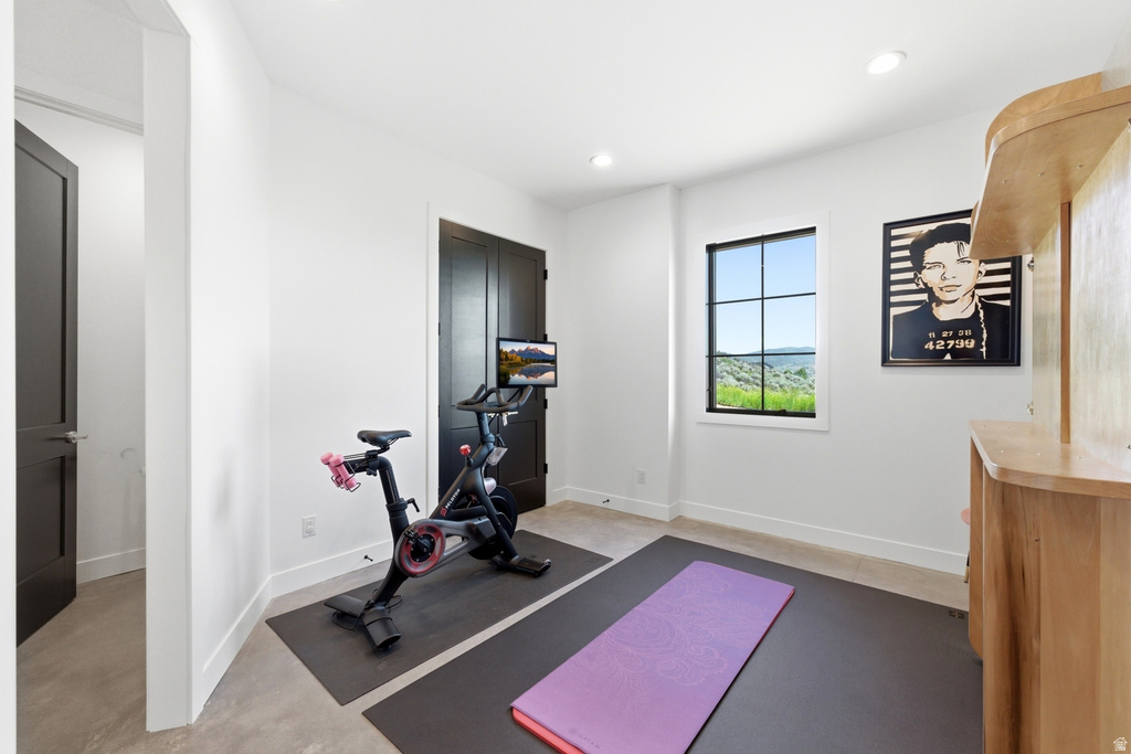 Versatile room featuring light-toned walls, recessed lighting, and a single window with dark framing
