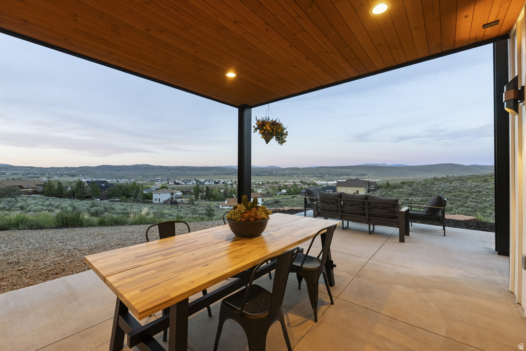 Spacious covered patio featuring a wood-finish ceiling, recessed lighting, and a concrete floor