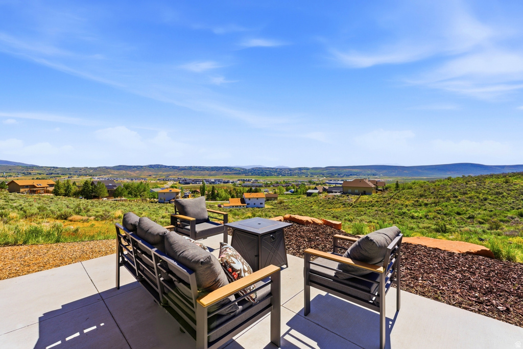 Expansive concrete patio with a broad, open-sky backdrop featuring distant hills