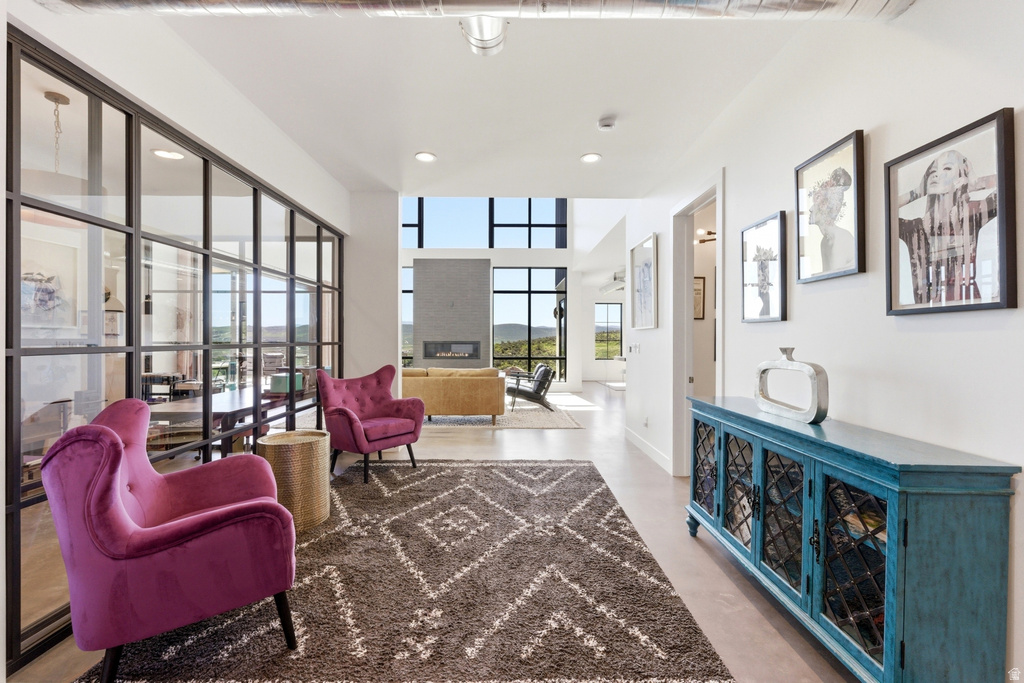 Expansive open-concept living space with high ceilings and recessed lighting