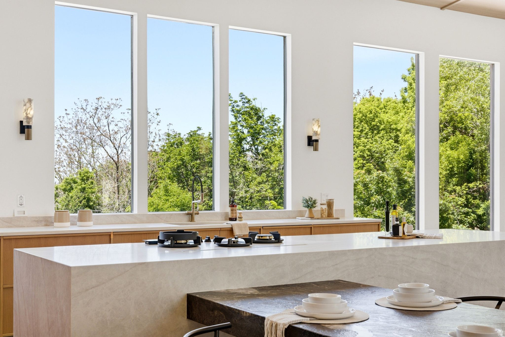 White kitchen with a substantial island featuring a cooktop