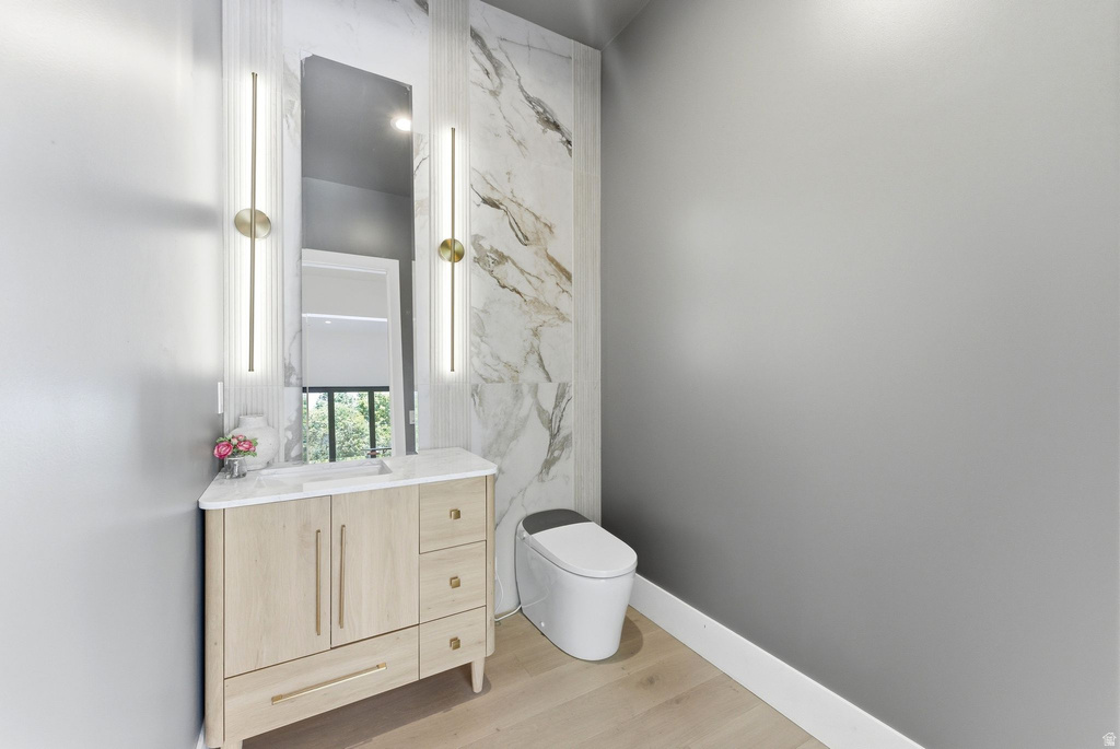 Light wood-finish vanity with a white countertop and rectangular sink