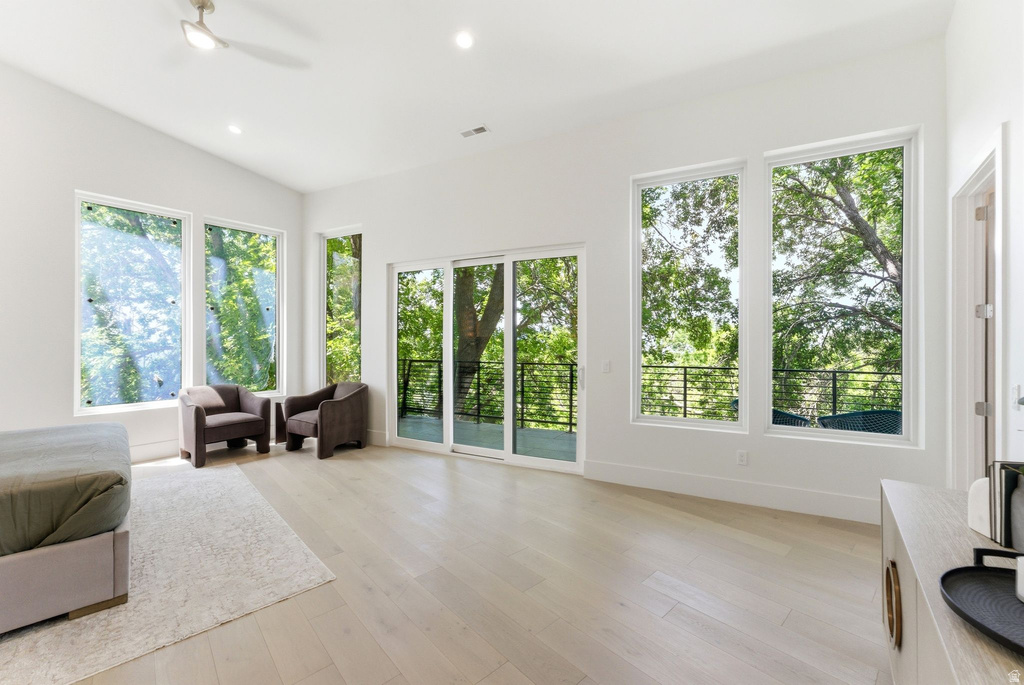 Expansive room featuring vaulted ceilings, recessed lighting, and wood-finish flooring