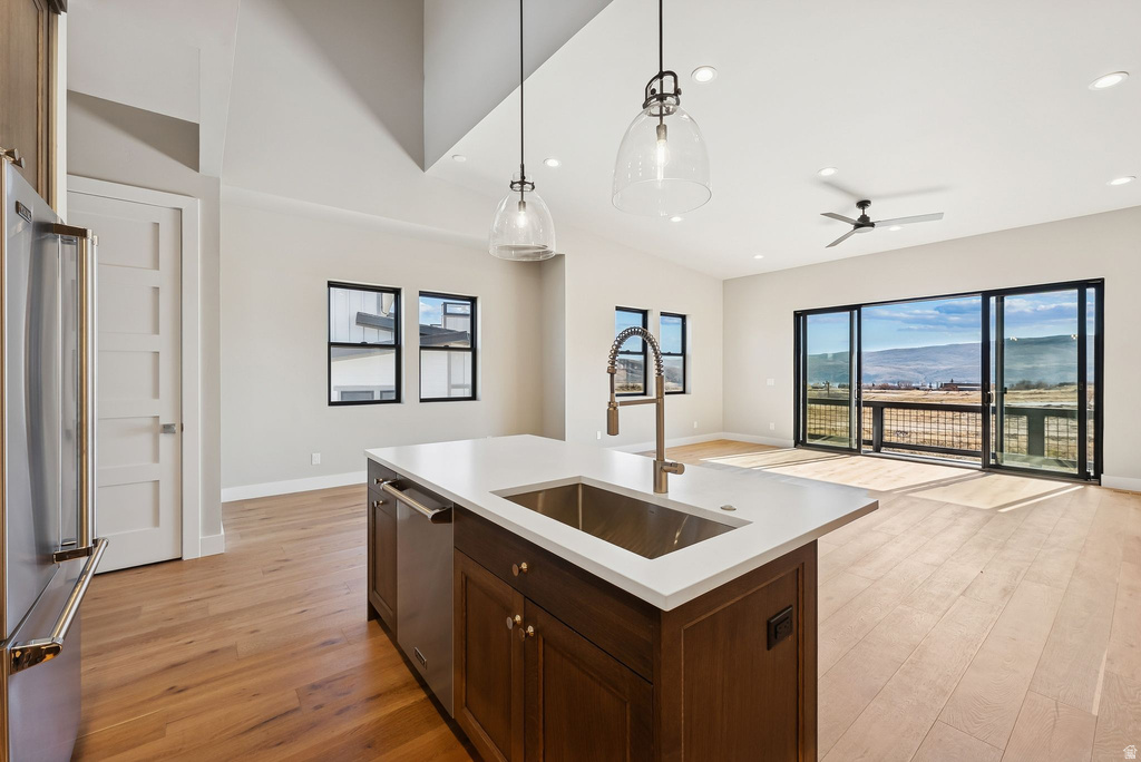 Open-concept living area featuring an expansive kitchen island with a stainless steel sink and gooseneck faucet