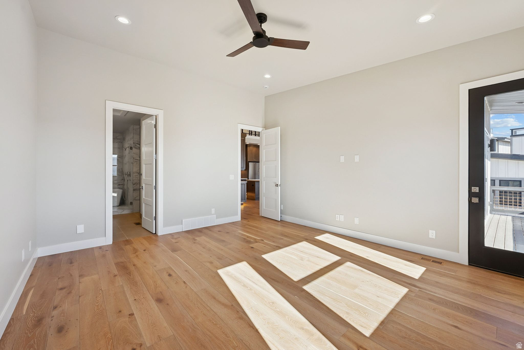 Spacious room featuring wood-finish flooring, recessed lighting, and a contemporary ceiling fan