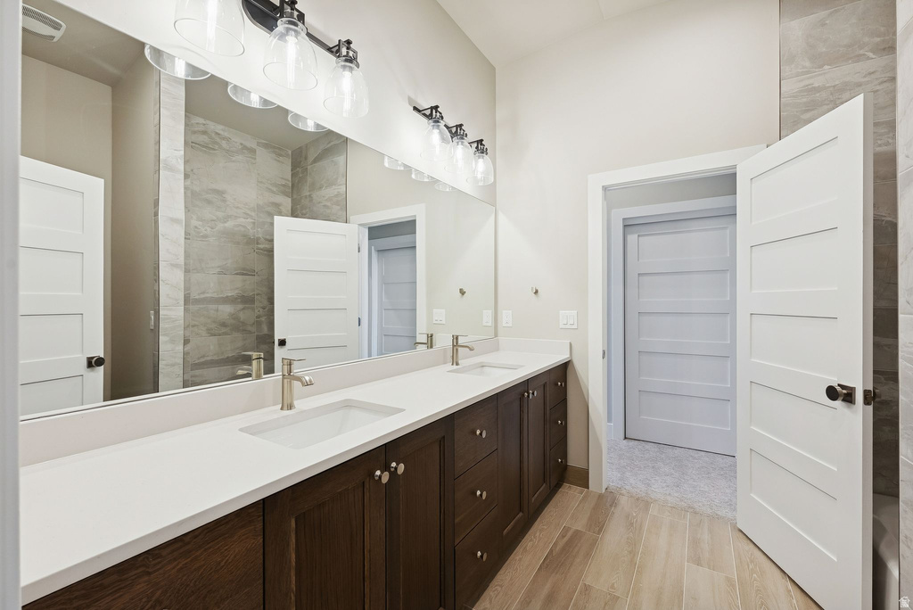 Dual vanity with integrated rectangular sinks, brushed nickel faucets, and white countertops