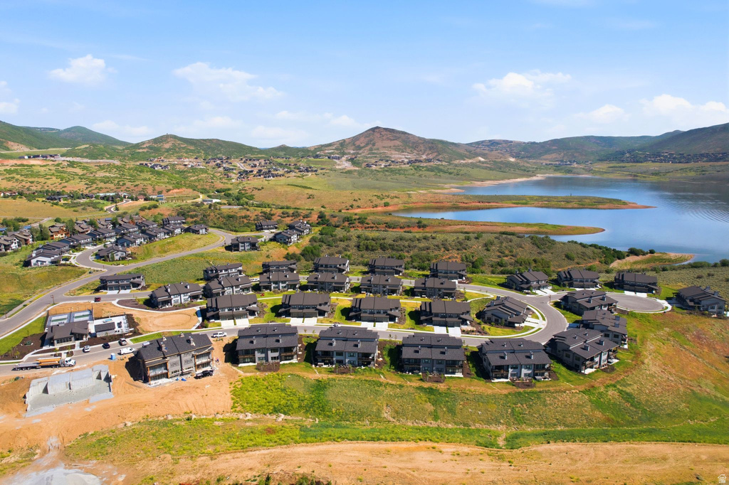 Aerial overview of a residential development featuring multiple dark-roofed homes
