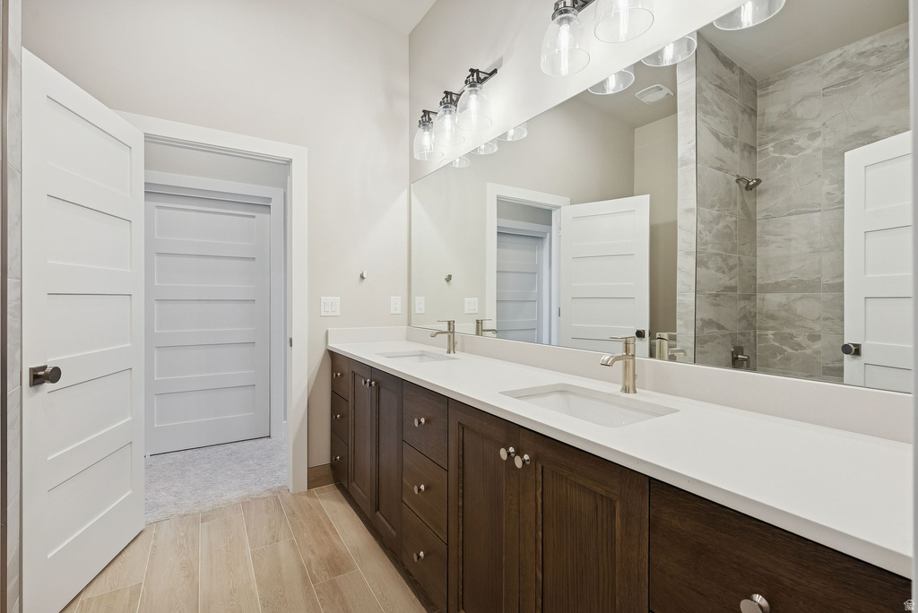 Dual vanity with a white countertop and wood-finish cabinetry